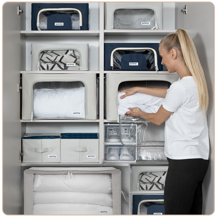 Lifestyle’owe zdjęcie przedstawia modelkę wkładającą ubranie do torby naszej marki. W tle widoczna zorganizowana szafa z torbami i organizerami na spodnie – estetyczne i funkcjonalne rozwiązanie do przechowywania.